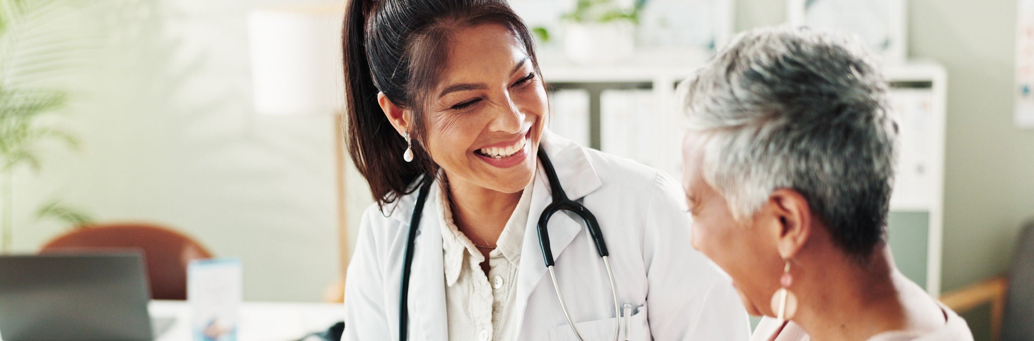 Mature woman, doctor and tablet for xray, support or conversation with cardiology checkup in office. Female person, medical professional and diagnosis talk for senior patient at clinic appointment