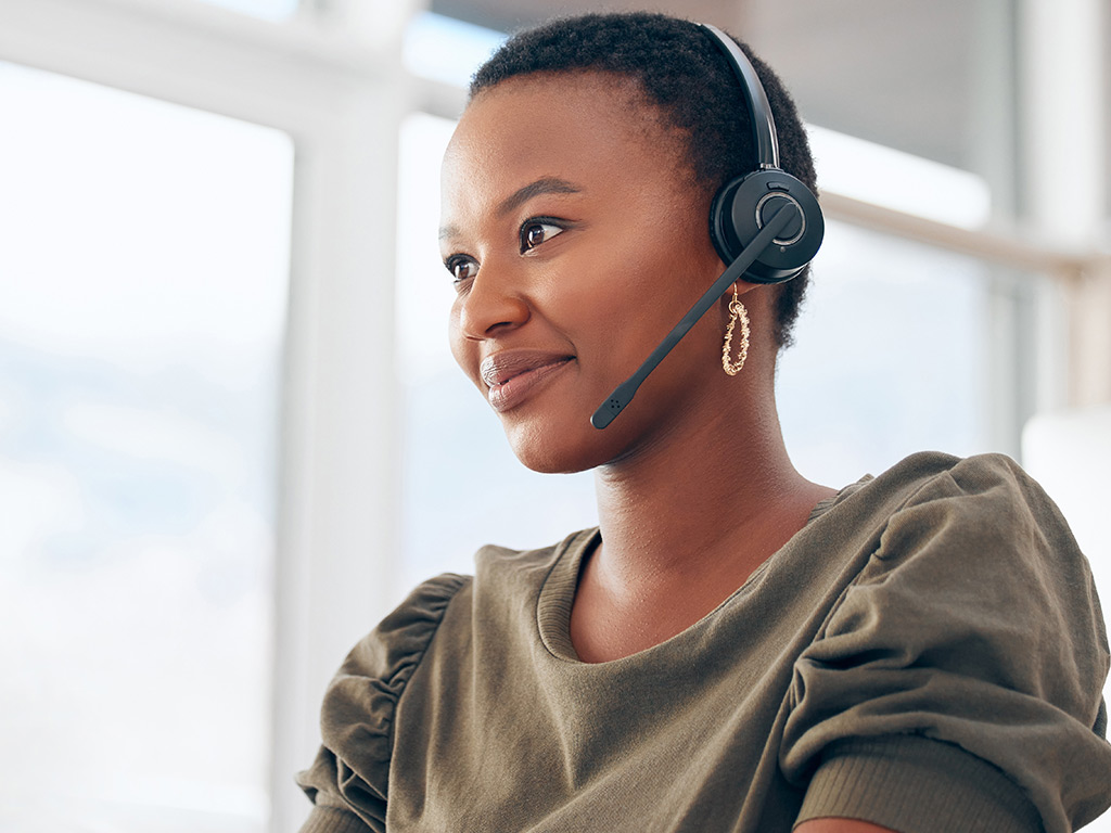 A woman talking on a headset.