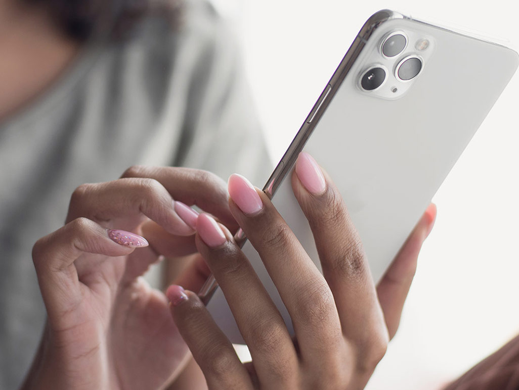 A close up image of a woman on her phone.