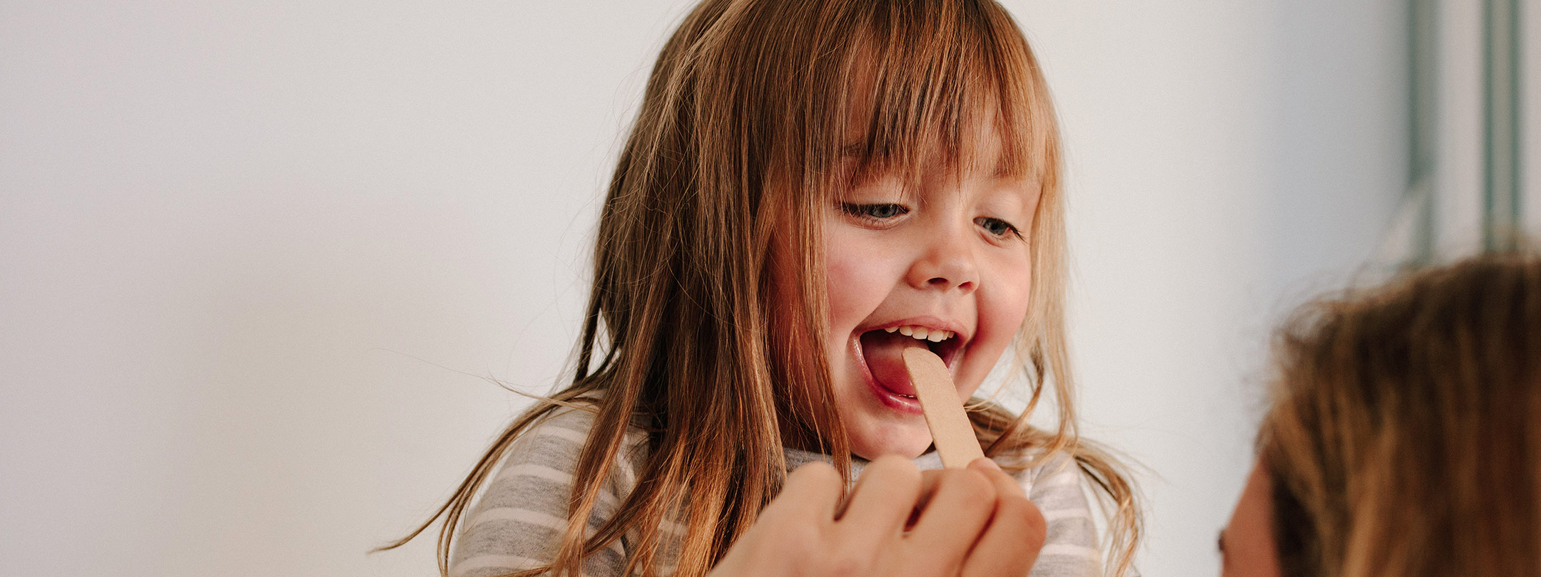 Doctor looking at girl's throat