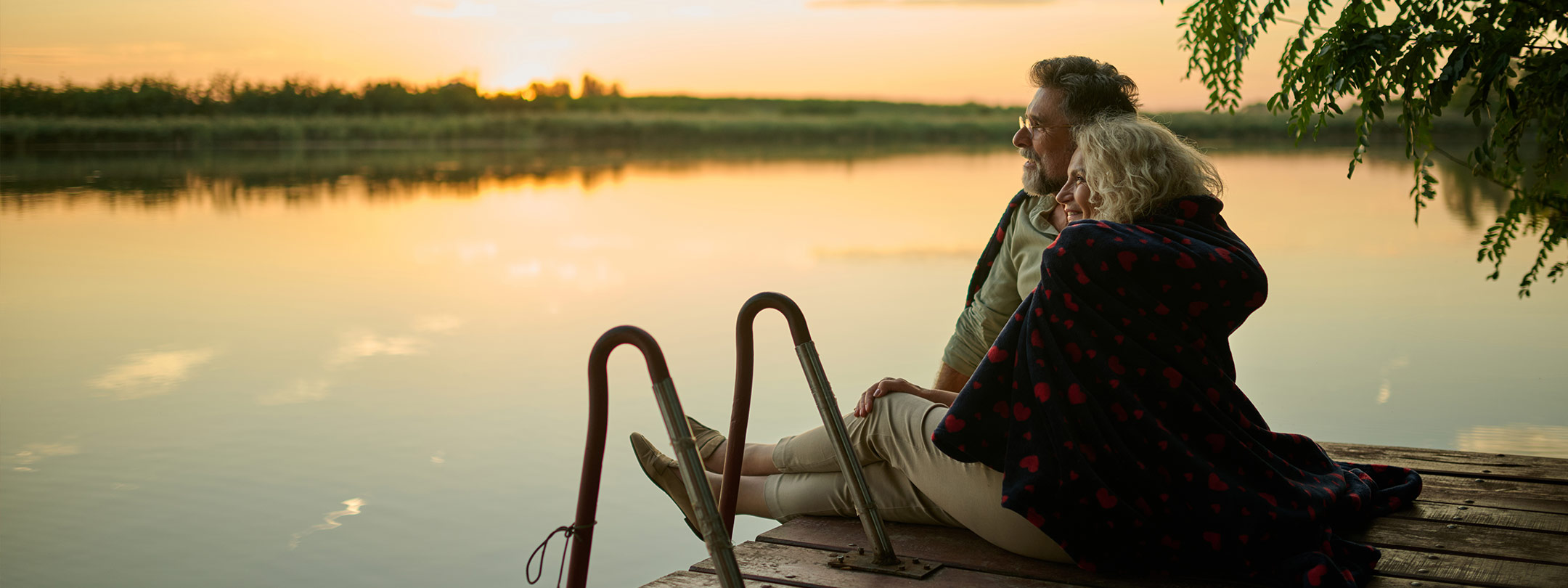 Couple watching the sunset from their dock