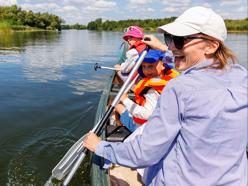 Happy family canoeing through a lake
