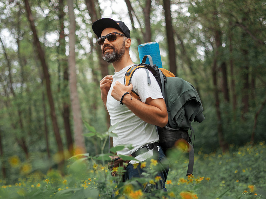 Man walks through forest on a hike