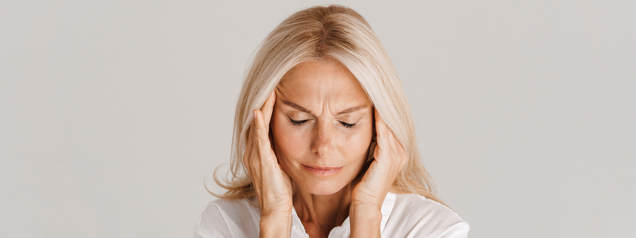 woman rubbing her temples 