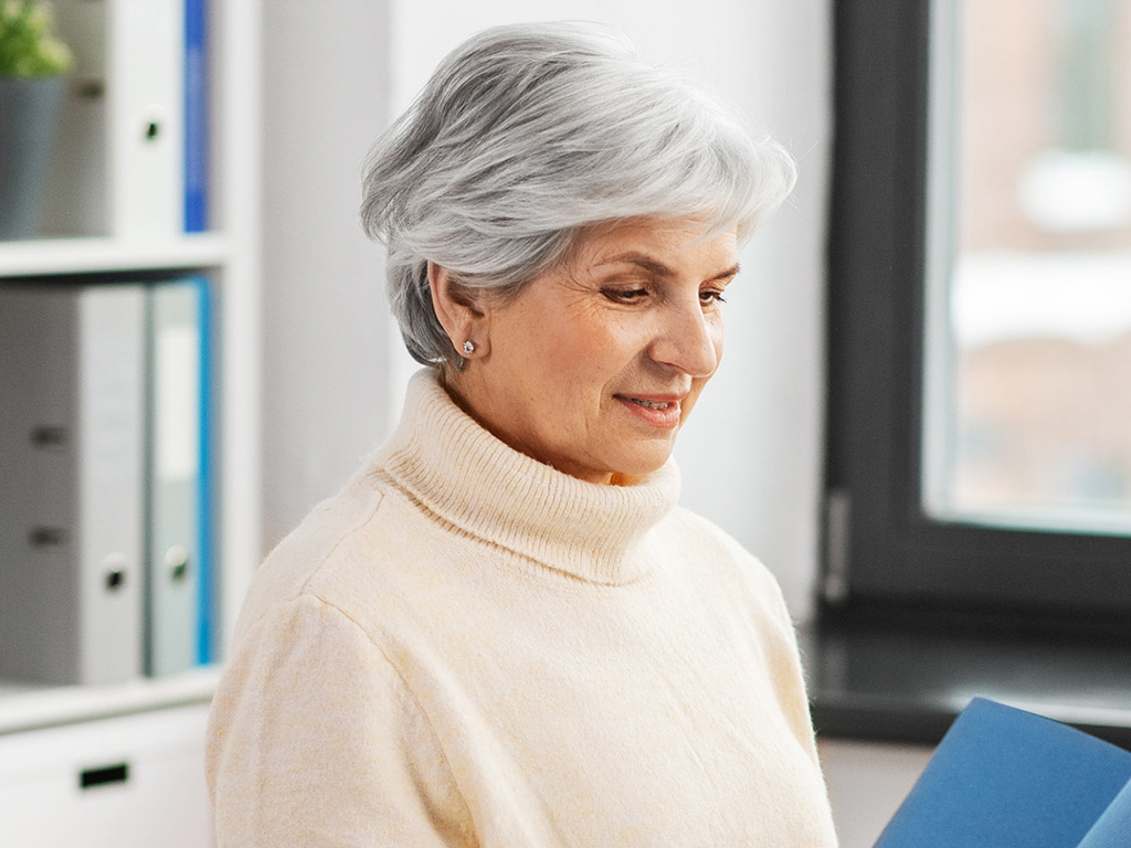 Older woman looking at a brochure
