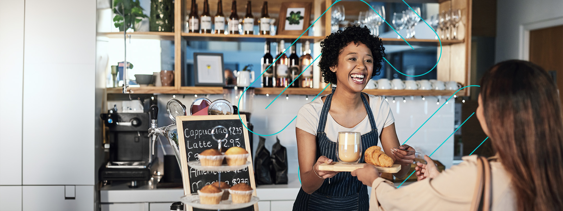 Woman serving a customer of a latte and croissant at a coffee shop