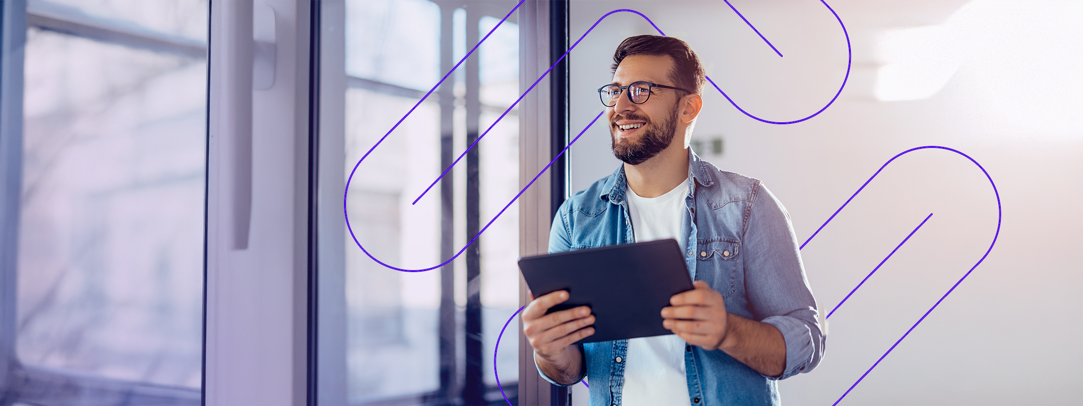 Man Holding Tablet and Smiling