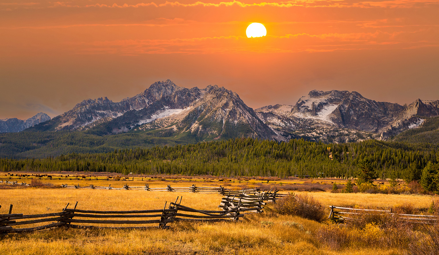 Idaho landscape picture of the a sunset, large field, mountains