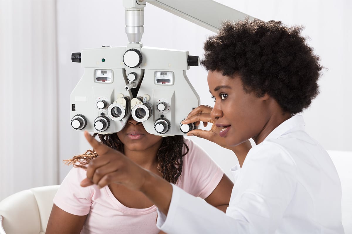eye doctor providing an eye exam to a patient