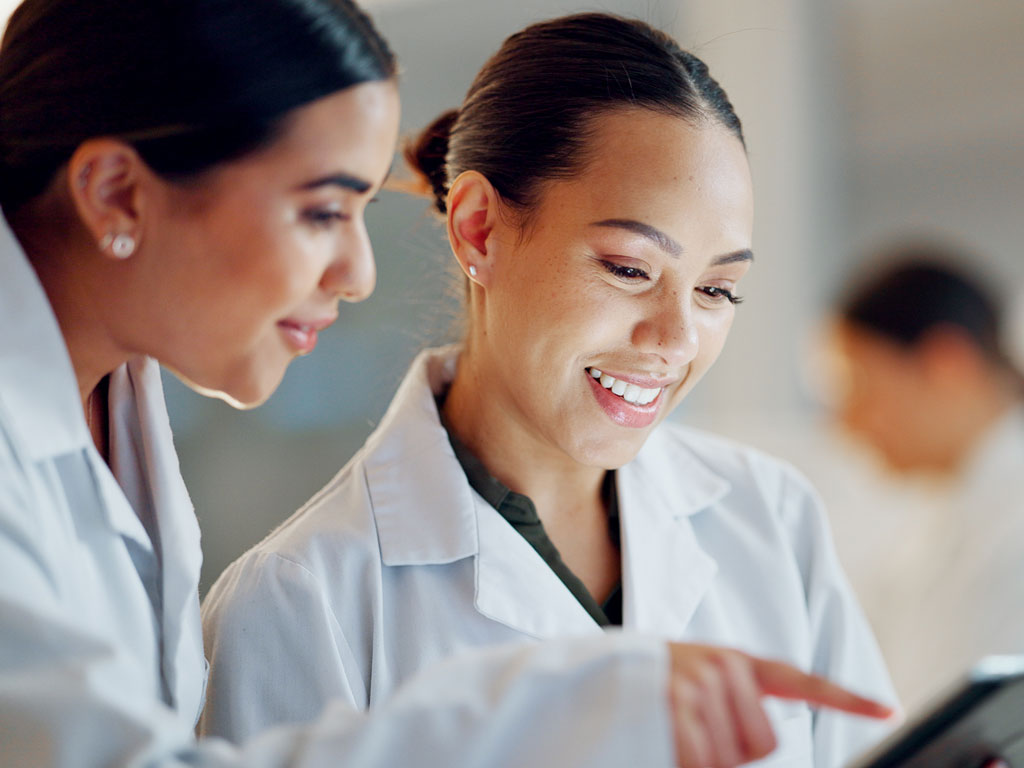 Two female doctors looking at a tablet screen
