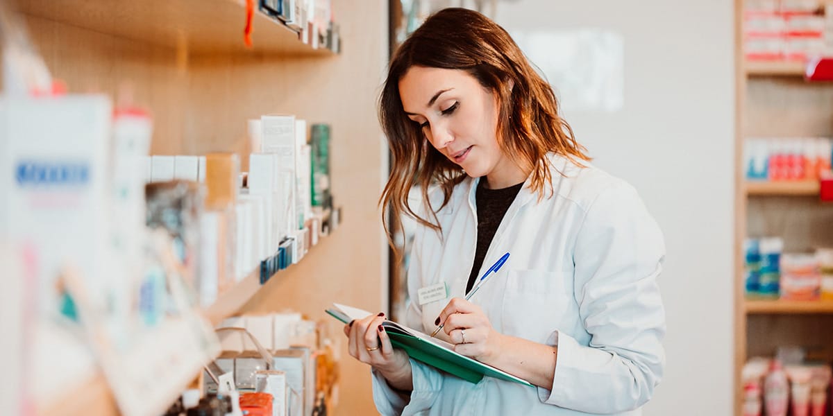 A nurse holding her chart and looking to the side.